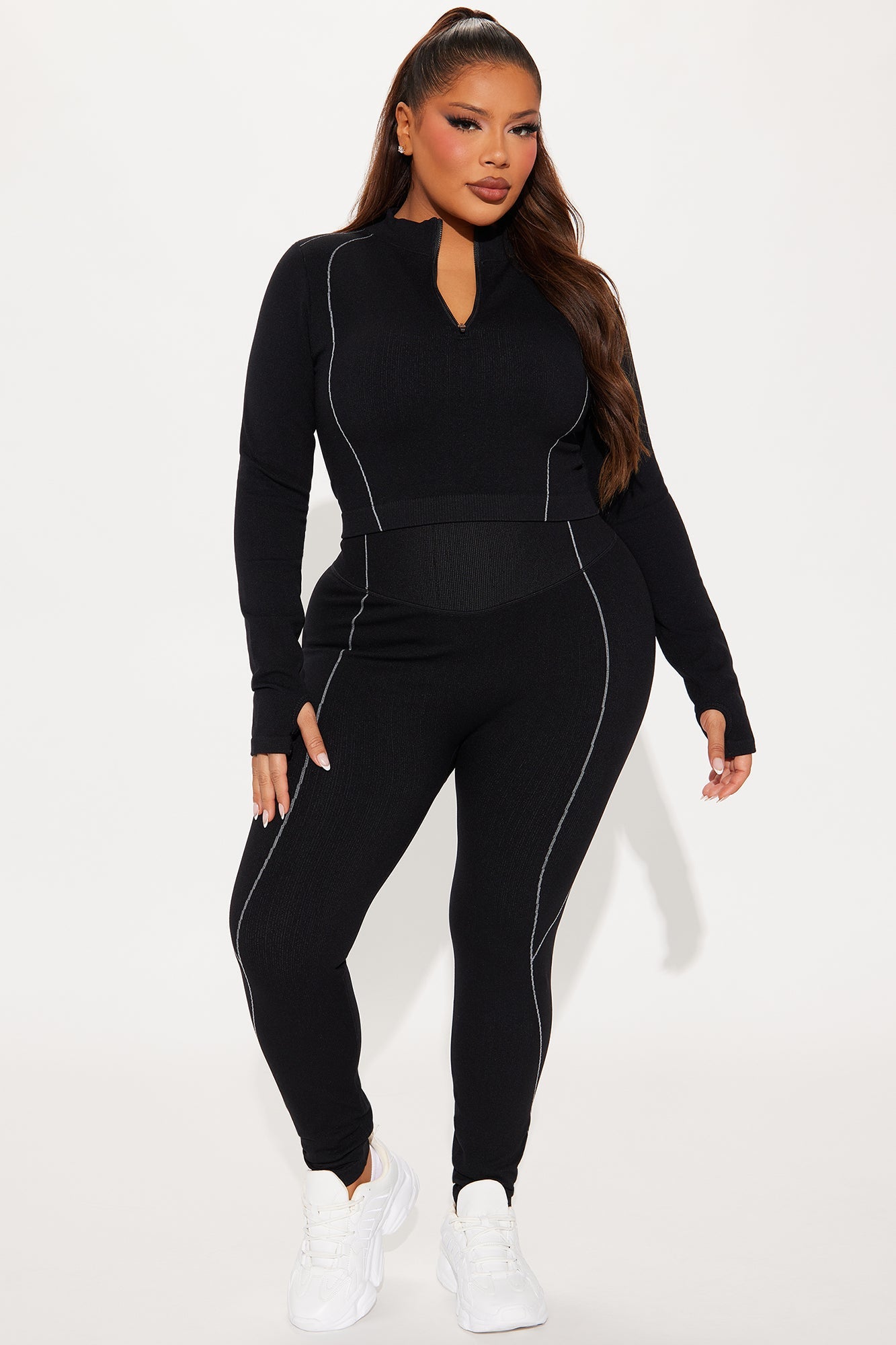 Fashion Nova women's black activewear set featuring a fitted top and leggings with stylish design