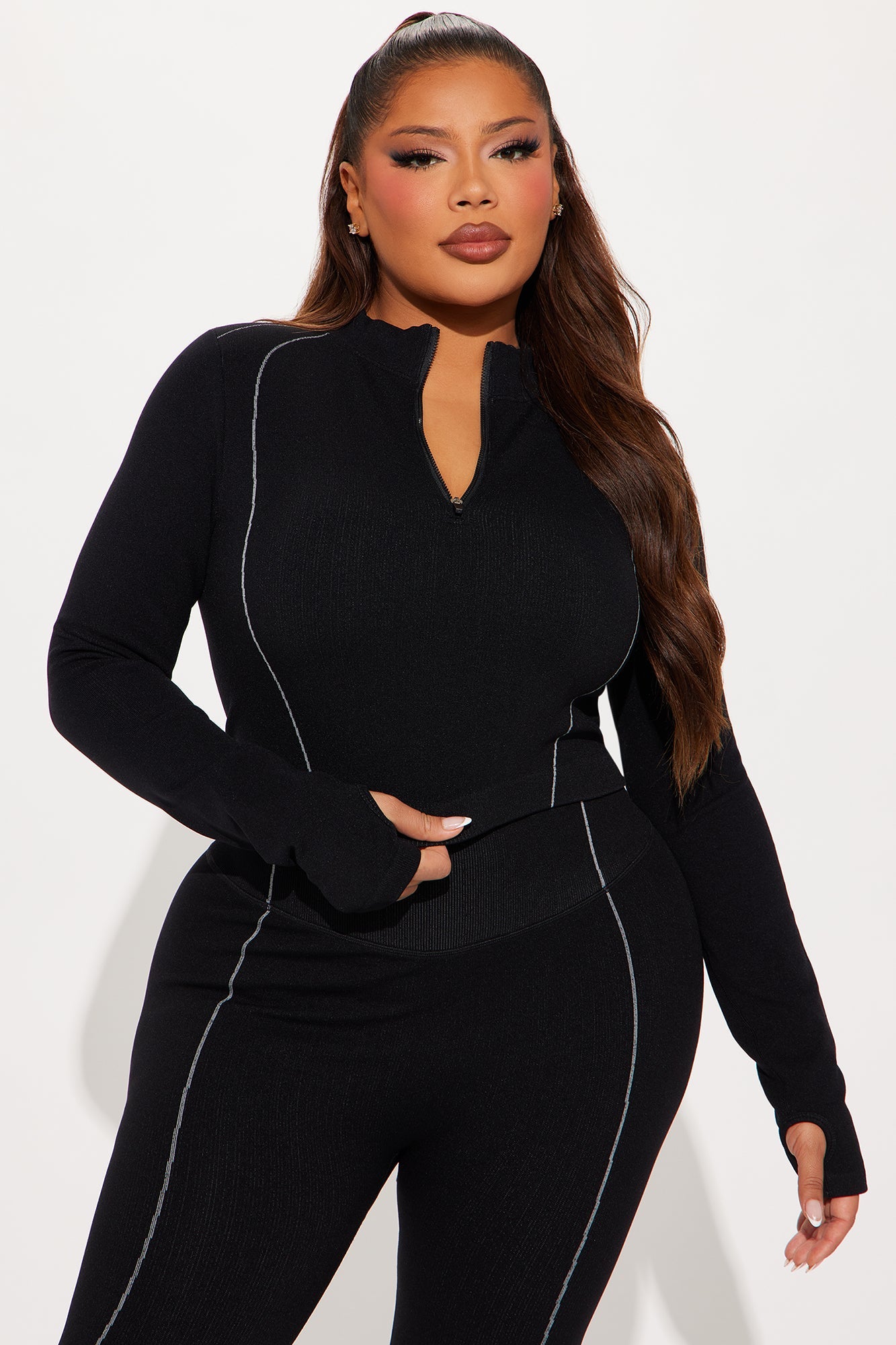 Fashion Nova women's black activewear set with stylish zip-up top and fitted pants